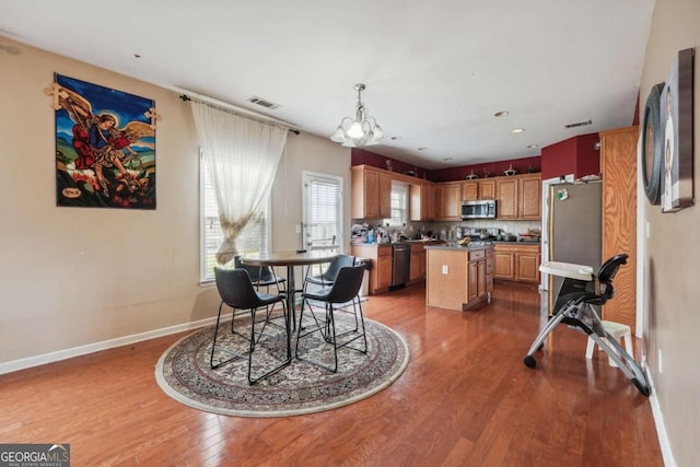 dining room with a chandelier and hardwood / wood-style floors