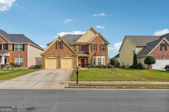 view of front of property featuring a front yard and a garage