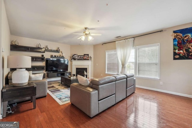 living room featuring wood-type flooring and ceiling fan