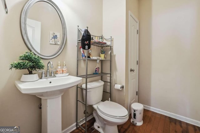 bathroom featuring hardwood / wood-style floors and toilet