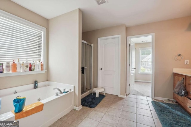 bathroom featuring vanity, tile patterned floors, and plus walk in shower