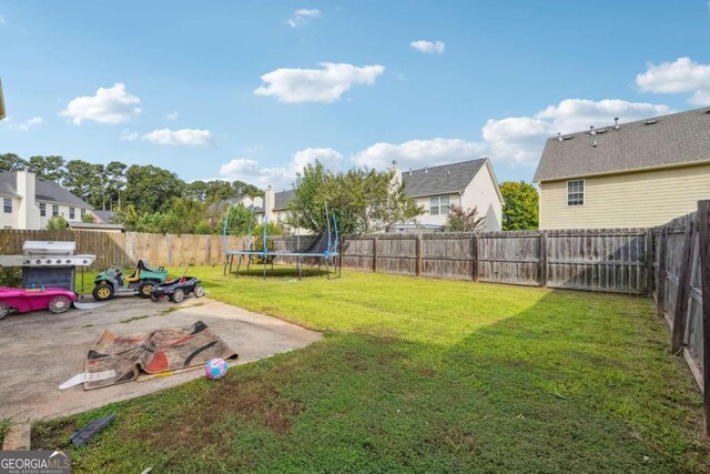 view of yard featuring a patio area and a trampoline