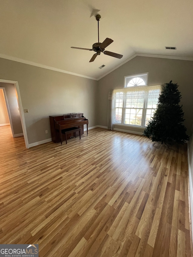 unfurnished living room with crown molding, vaulted ceiling, wood-type flooring, and ceiling fan