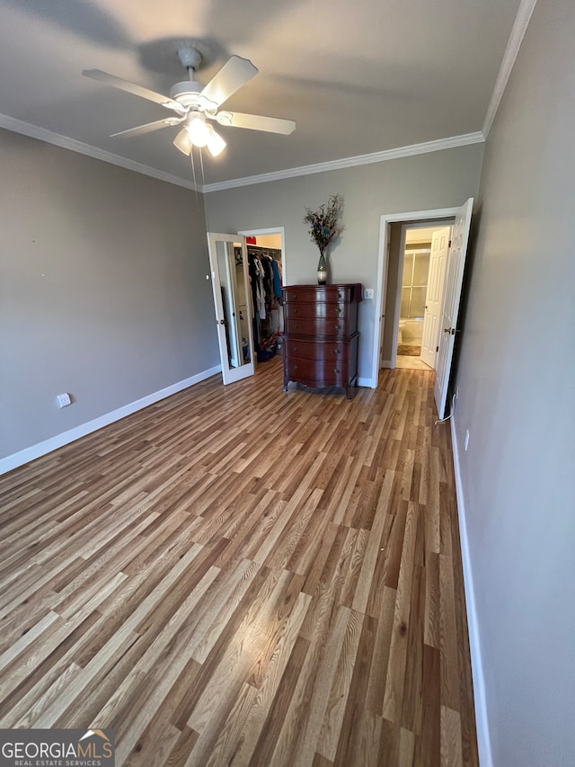 interior space featuring ceiling fan, hardwood / wood-style flooring, and ornamental molding