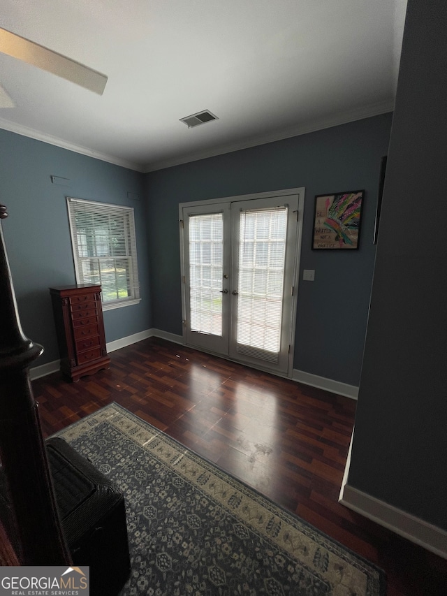 living room featuring ornamental molding, dark wood-type flooring, and french doors