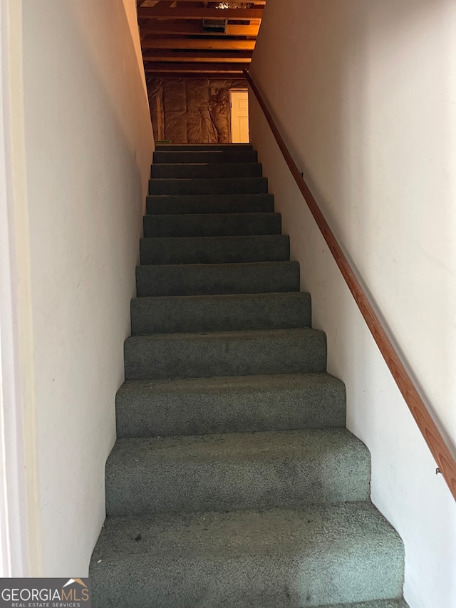 stairs featuring vaulted ceiling