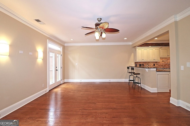 unfurnished living room with dark wood-type flooring, ceiling fan, french doors, and ornamental molding