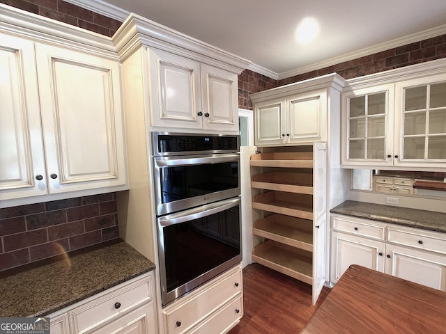 kitchen featuring white cabinets, ornamental molding, stainless steel double oven, and wine cooler