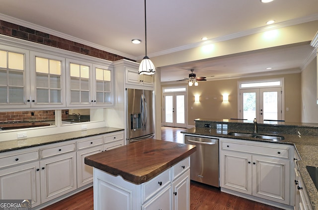 kitchen featuring sink, white cabinets, french doors, and stainless steel appliances