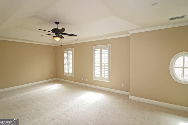 unfurnished room featuring a wealth of natural light, light colored carpet, and crown molding