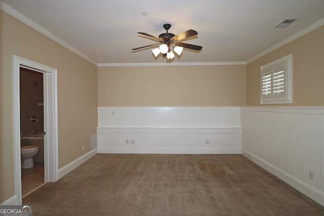 empty room with ceiling fan, crown molding, and carpet floors