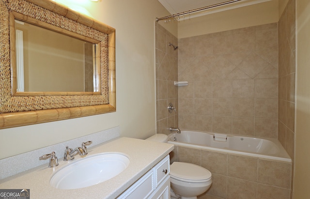 full bathroom with vanity, tiled shower / bath, and toilet