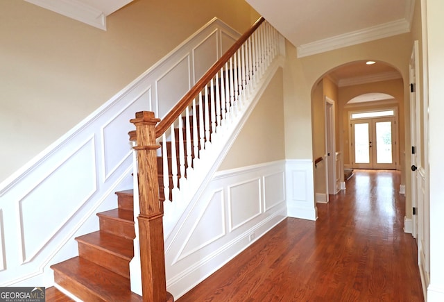 stairway featuring french doors, hardwood / wood-style flooring, and crown molding