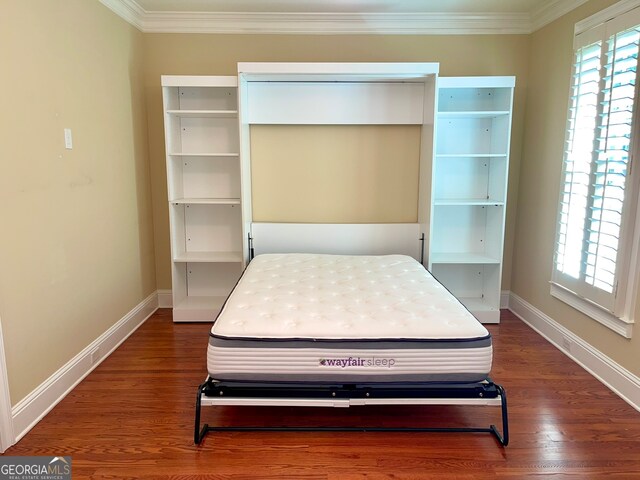 bedroom featuring dark hardwood / wood-style flooring and crown molding