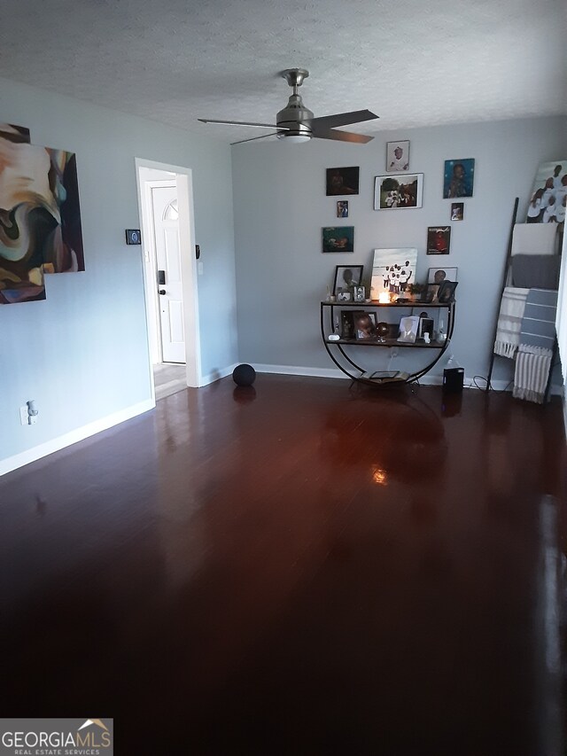 interior space featuring a textured ceiling and ceiling fan