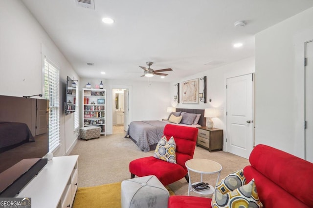 carpeted bedroom featuring ensuite bathroom and ceiling fan