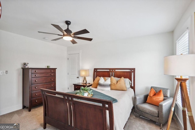 bedroom featuring light colored carpet and ceiling fan