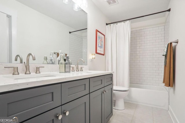 full bathroom featuring vanity, toilet, tile patterned floors, and shower / bath combo