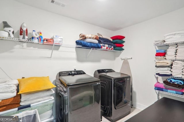 clothes washing area with independent washer and dryer