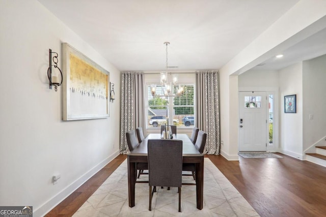 dining room with hardwood / wood-style flooring, a chandelier, and a healthy amount of sunlight