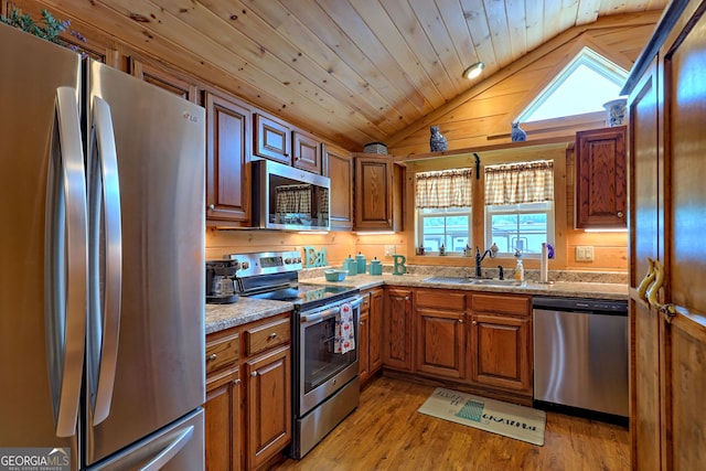 kitchen featuring vaulted ceiling, appliances with stainless steel finishes, wood ceiling, sink, and plenty of natural light