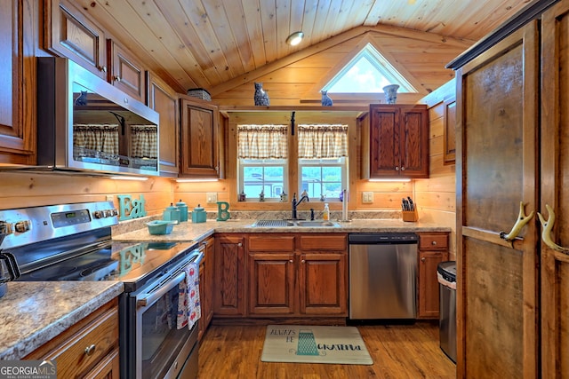 kitchen featuring plenty of natural light, wood ceiling, stainless steel appliances, and vaulted ceiling