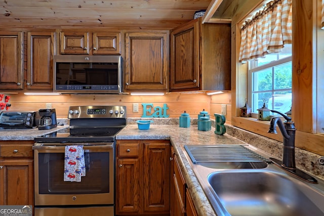 kitchen with sink, appliances with stainless steel finishes, and wooden ceiling