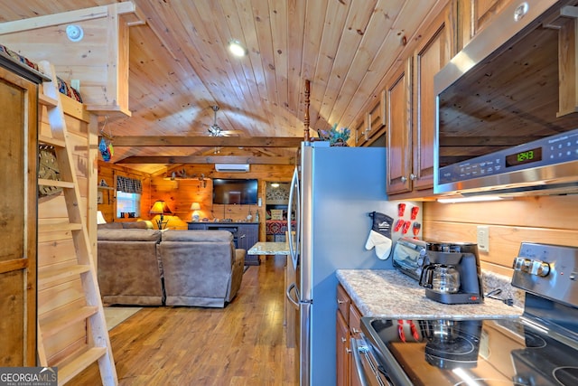 kitchen with black electric range, light hardwood / wood-style flooring, wood walls, and lofted ceiling