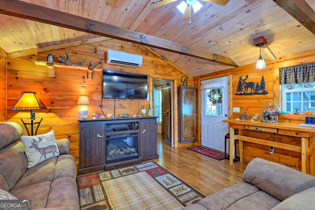 living room featuring ceiling fan, wooden walls, and light hardwood / wood-style floors