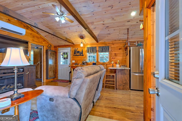 living room with wood walls, light hardwood / wood-style floors, an AC wall unit, ceiling fan, and vaulted ceiling with beams