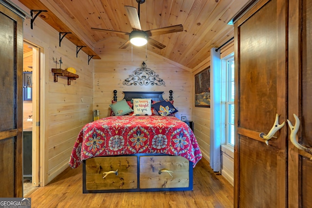 bedroom featuring wooden ceiling, light hardwood / wood-style flooring, lofted ceiling, wood walls, and ceiling fan