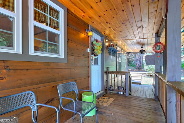 sunroom with ceiling fan and wood ceiling