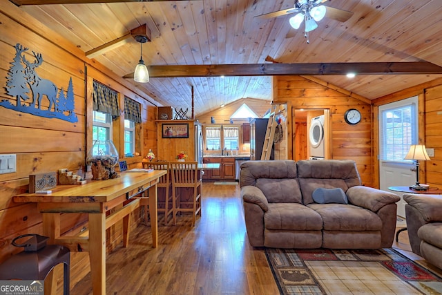 living room featuring ceiling fan, hardwood / wood-style floors, wooden walls, and lofted ceiling with beams