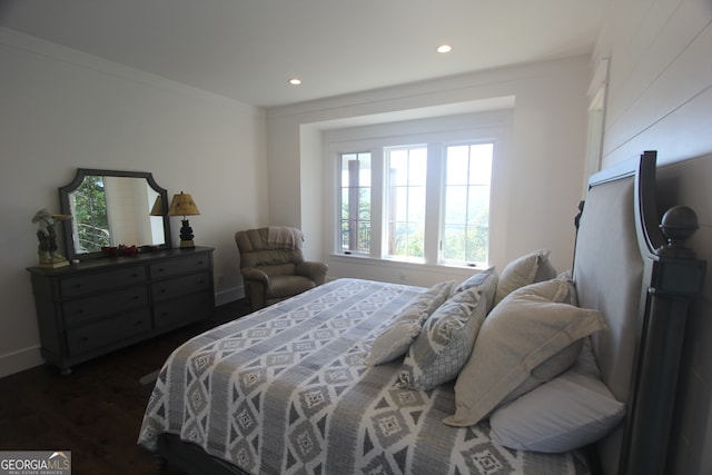 bedroom featuring dark hardwood / wood-style floors and crown molding