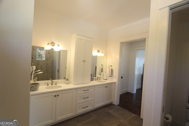 bathroom with walk in shower, vanity, and hardwood / wood-style flooring