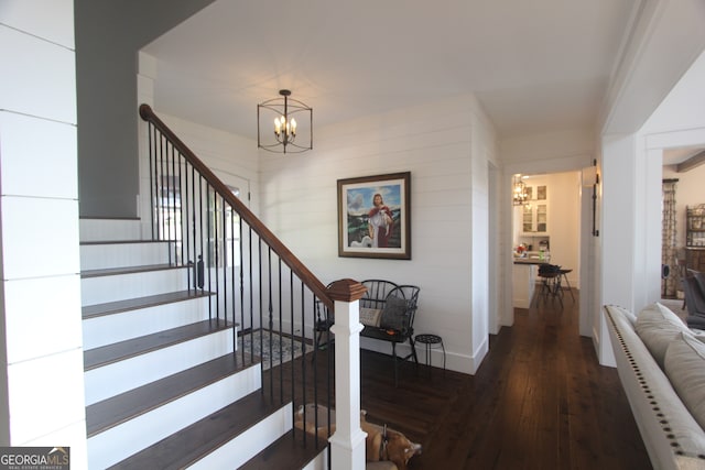 stairs with a notable chandelier and wood-type flooring