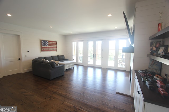 living room with dark hardwood / wood-style floors and a large fireplace