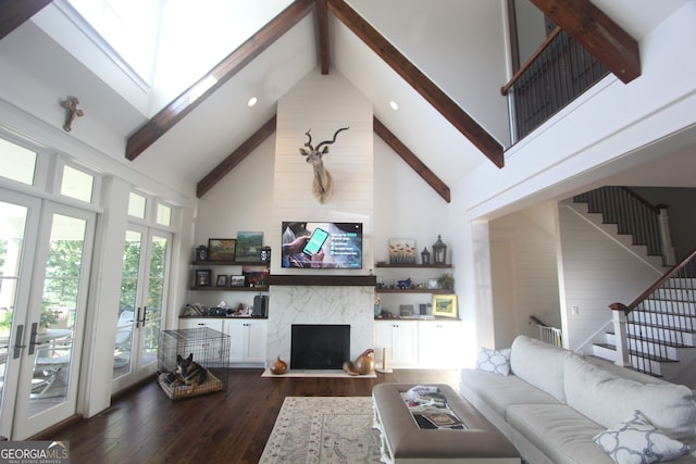 living room featuring french doors, dark hardwood / wood-style floors, a high end fireplace, and high vaulted ceiling