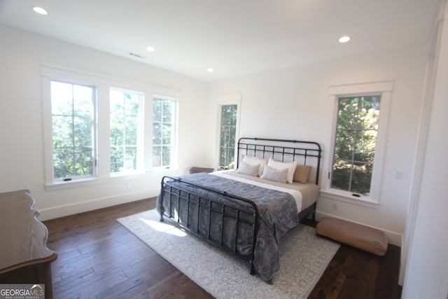 bedroom with dark hardwood / wood-style floors