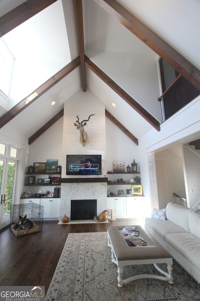 living room with a fireplace, beam ceiling, dark wood-type flooring, and high vaulted ceiling