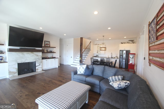 living room with dark hardwood / wood-style floors and sink