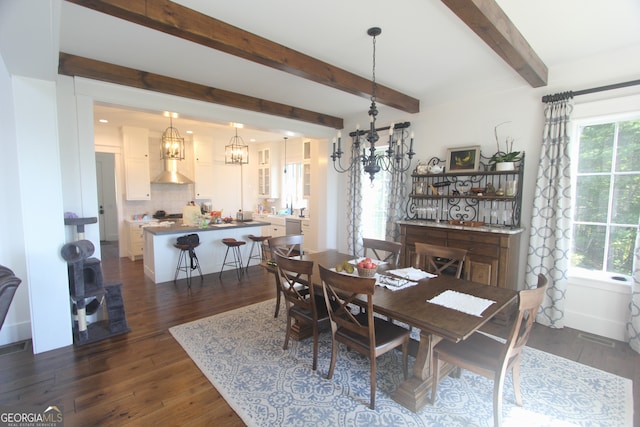 dining space featuring an inviting chandelier, beam ceiling, and dark hardwood / wood-style flooring