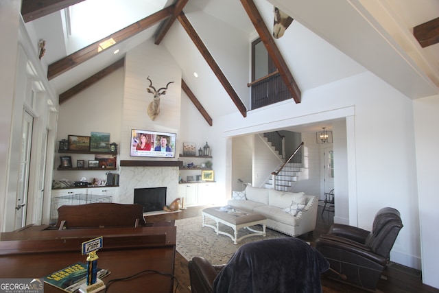 living room with high vaulted ceiling, beam ceiling, a high end fireplace, and hardwood / wood-style flooring