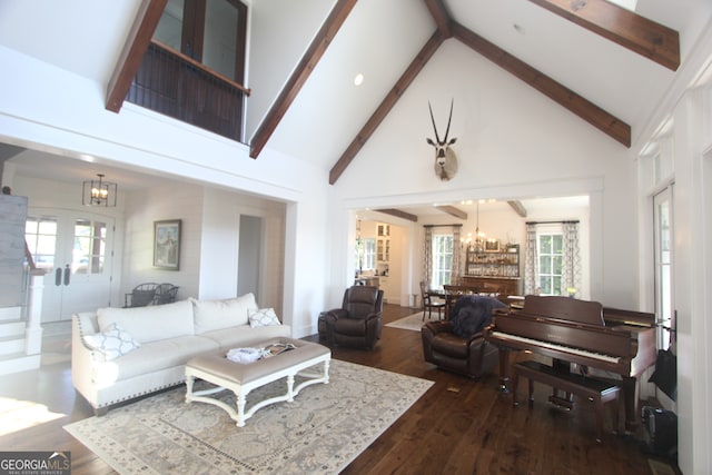 living room with an inviting chandelier, beam ceiling, dark hardwood / wood-style flooring, and high vaulted ceiling