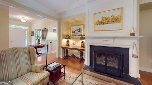 living room with ornamental molding and hardwood / wood-style floors