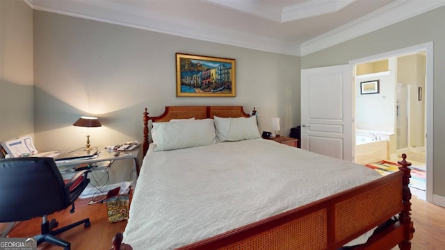 bedroom featuring crown molding, connected bathroom, and light hardwood / wood-style floors