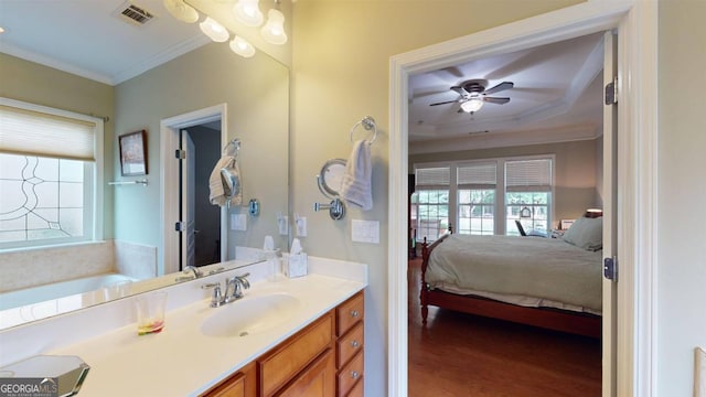 bathroom with crown molding, vanity, wood-type flooring, and ceiling fan