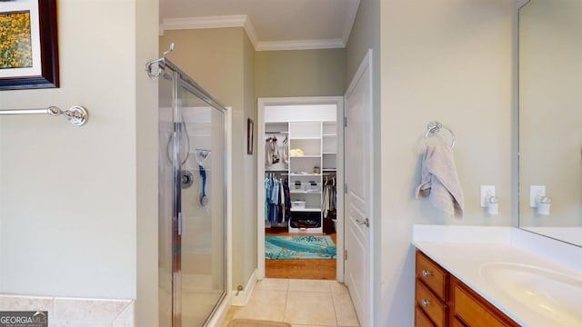 bathroom with crown molding, vanity, walk in shower, and tile patterned floors