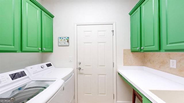 washroom featuring washer and clothes dryer and cabinets