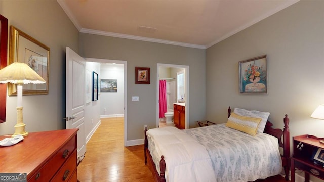 bedroom with light hardwood / wood-style floors, ensuite bathroom, and ornamental molding